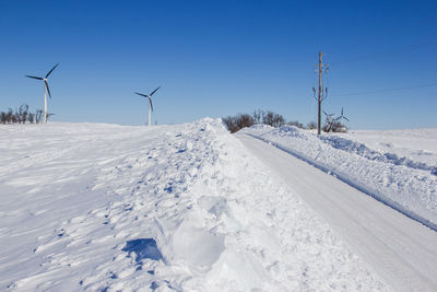 Large snow drift along the side of the road.