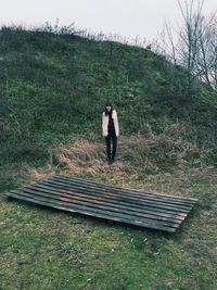 Full length of woman standing on footpath