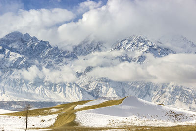 Scenic view of snow covered mountains against sky