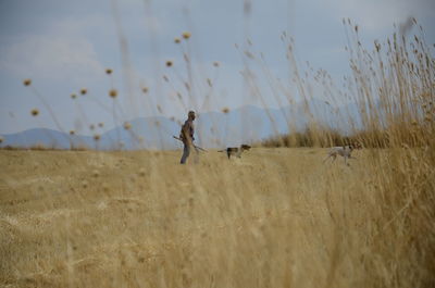 Side view of man walking on field