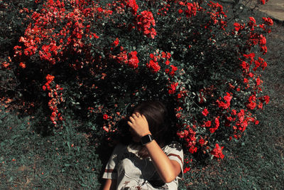 Woman lying down on field against plants