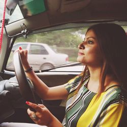 Portrait of woman sitting in car