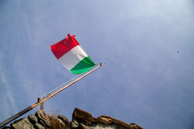 Low angle view of flag against sky