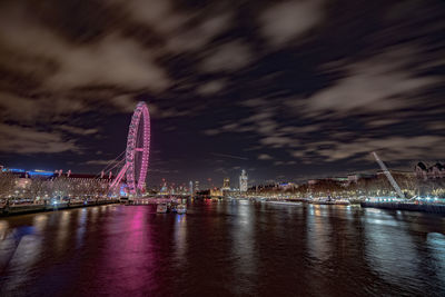 Illuminated city against sky at night