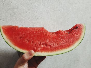 Close-up of hand holding strawberry