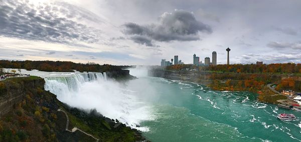 Scenic view of waterfall against sky