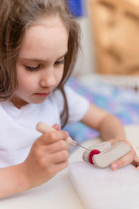 Felt wool craft handmade needle. little kid girl artisan hand makes creative toy made of sheep hair