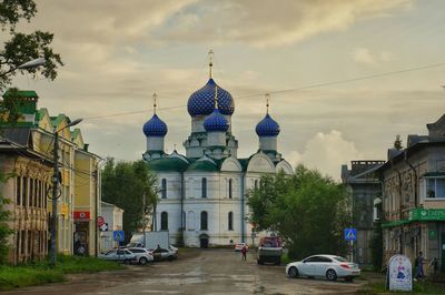 Street amidst buildings in city against sky