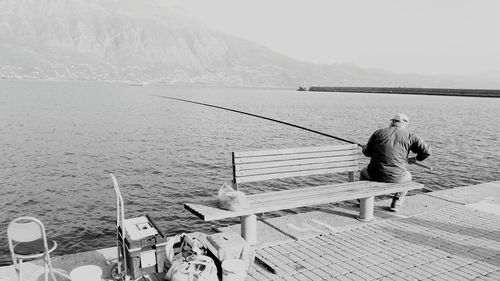 Men standing on shore against sky