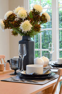 Flower vase on table at home