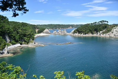 Scenic view of waterfall against sky