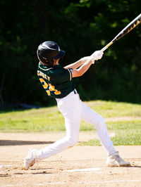 Rear view of man playing with ball on field