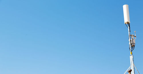 Low angle view of street light against clear blue sky