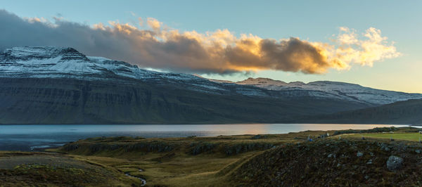 Scenic view of snowcapped mountains against sky during sunset