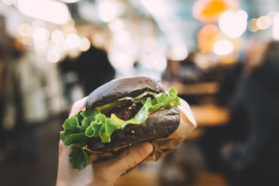 Close-up of hand holding burger