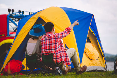 Rear view of people on tent