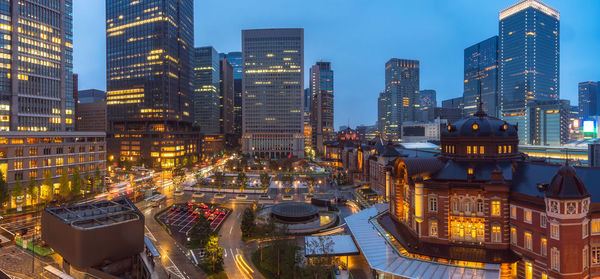 Aerial view of buildings in city at dusk