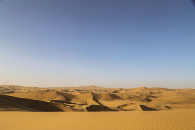 Scenic view of desert against clear sky