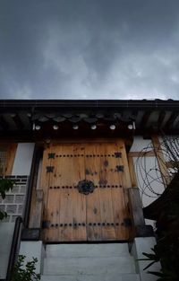 Low angle view of building against cloudy sky