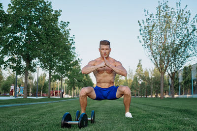 Portrait of young woman exercising in park