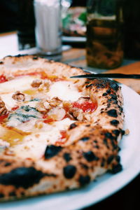 Close-up of pizza in plate on table