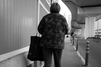 Rear view of people walking in building