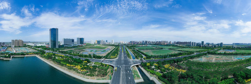 High angle view of road by buildings against sky