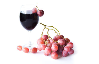 Close-up of grapes against white background