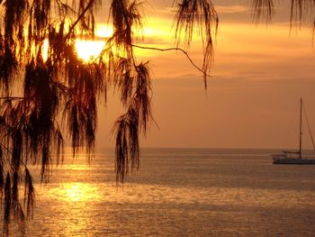 Scenic view of sea against sunset sky