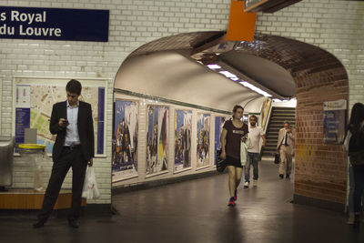 Man and woman walking in corridor of building