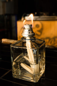 Close-up of burning oil lamp on table