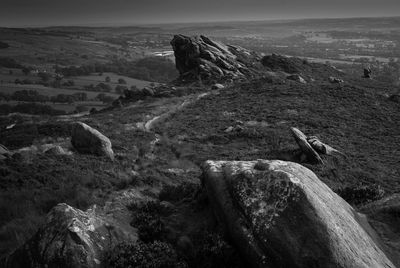 Rock formations on landscape against sky