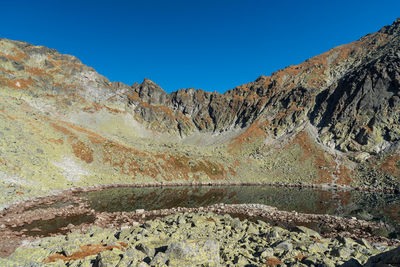 Scenic view of mountains against clear blue sky