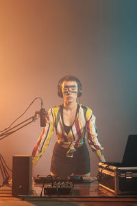 Portrait of young man sitting on stage