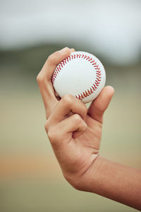 Cropped hand holding baseball