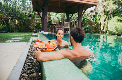 Portrait of a smiling young woman swimming pool