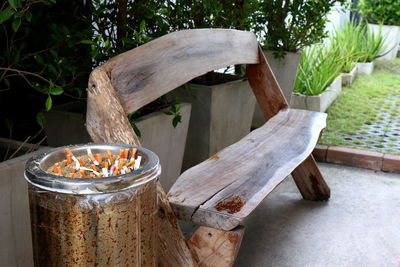 Close-up of wooden table by plants in yard