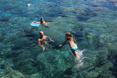 High angle view of family enjoying in sea