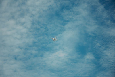 Low angle view of airplane flying in sky