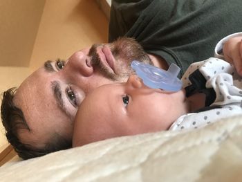 Portrait of baby lying down on bed