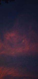 Low angle view of dramatic sky at night