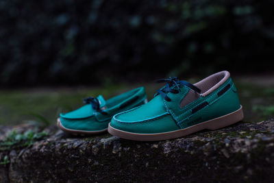 Close-up of shoes on rock