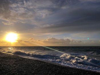 Scenic view of beach against sky during sunset