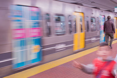 People walking on railroad station platform