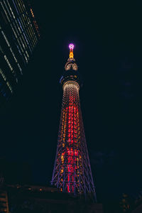 Low angle view of illuminated buildings against sky at night