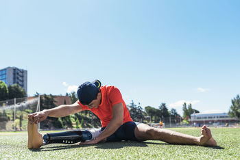 Man with prostethic leg stretching