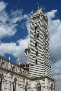 Low angle view of building against cloudy sky