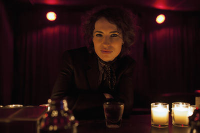 Woman sitting at a bar in a nightclub