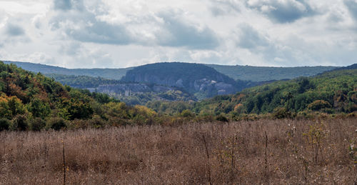 View of countryside landscape against cloudy sky