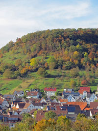 High angle view of houses and trees against sky